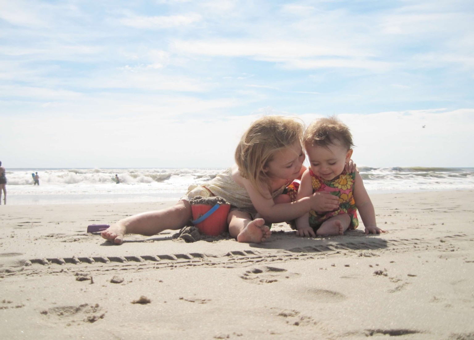 Two children sharing a moment on the beach