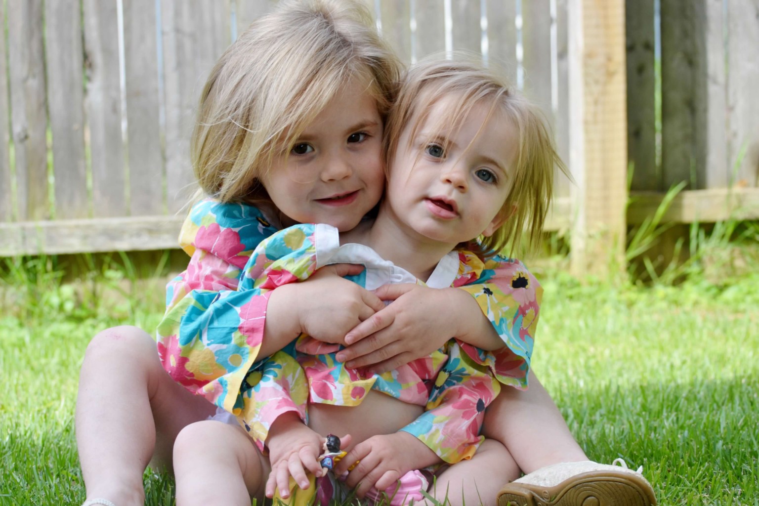 Two sisters embracing in a garden